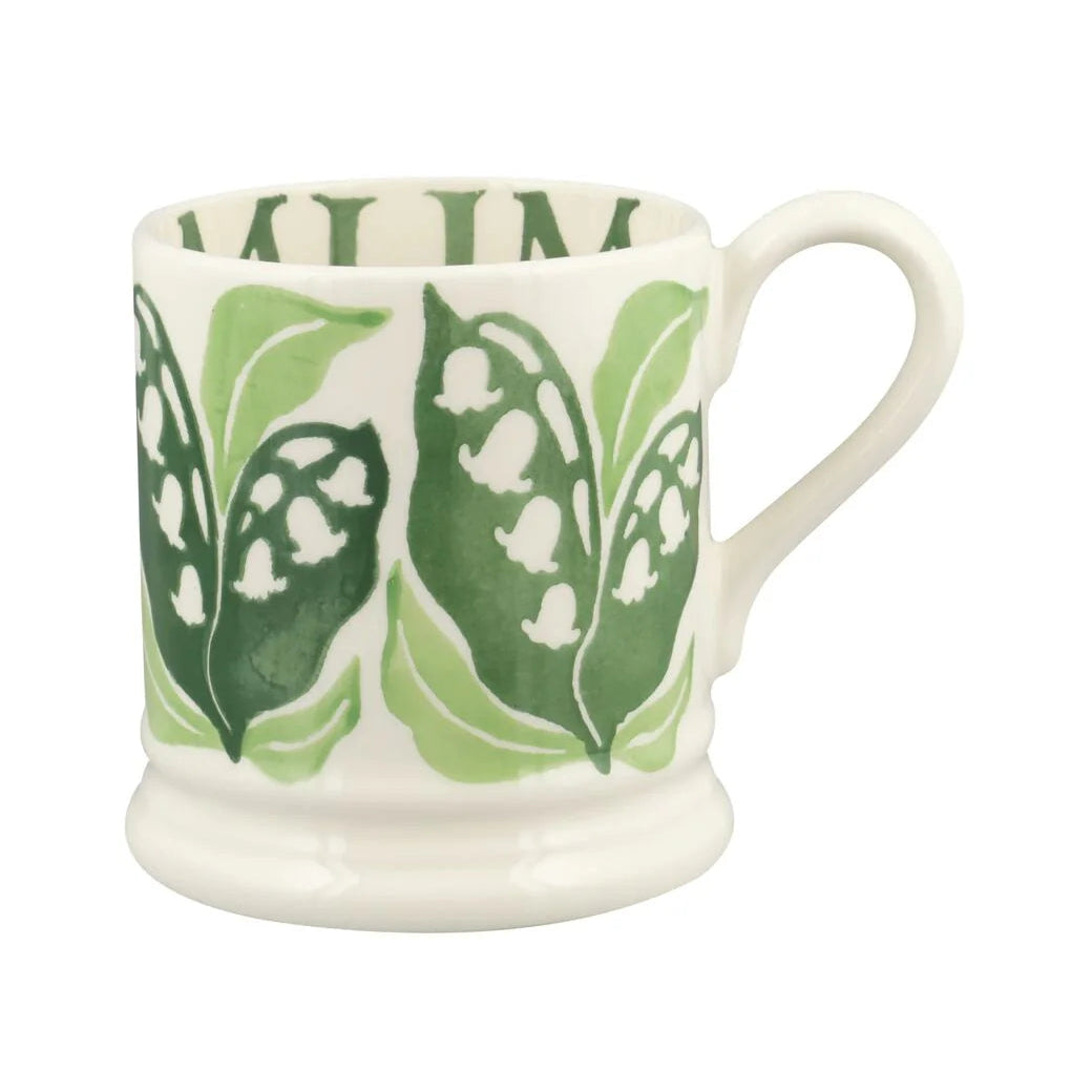 White mug with green leaf pattern on a white background