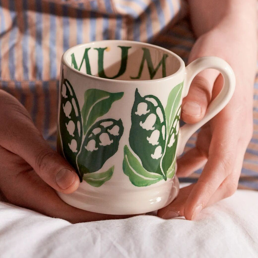 White mug with green leaf pattern on a white background