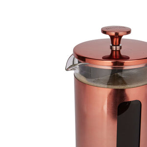 Copper French press coffee maker on a white background